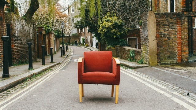 an old chair in the middle of a street